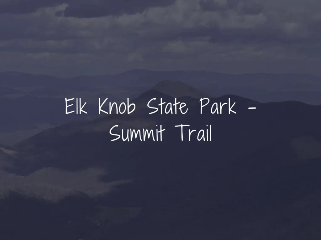 Blue-tinted mountain range under a cloudy sky with a white handwritten title reading 'Elk Knob State Park – Summit Trail'.